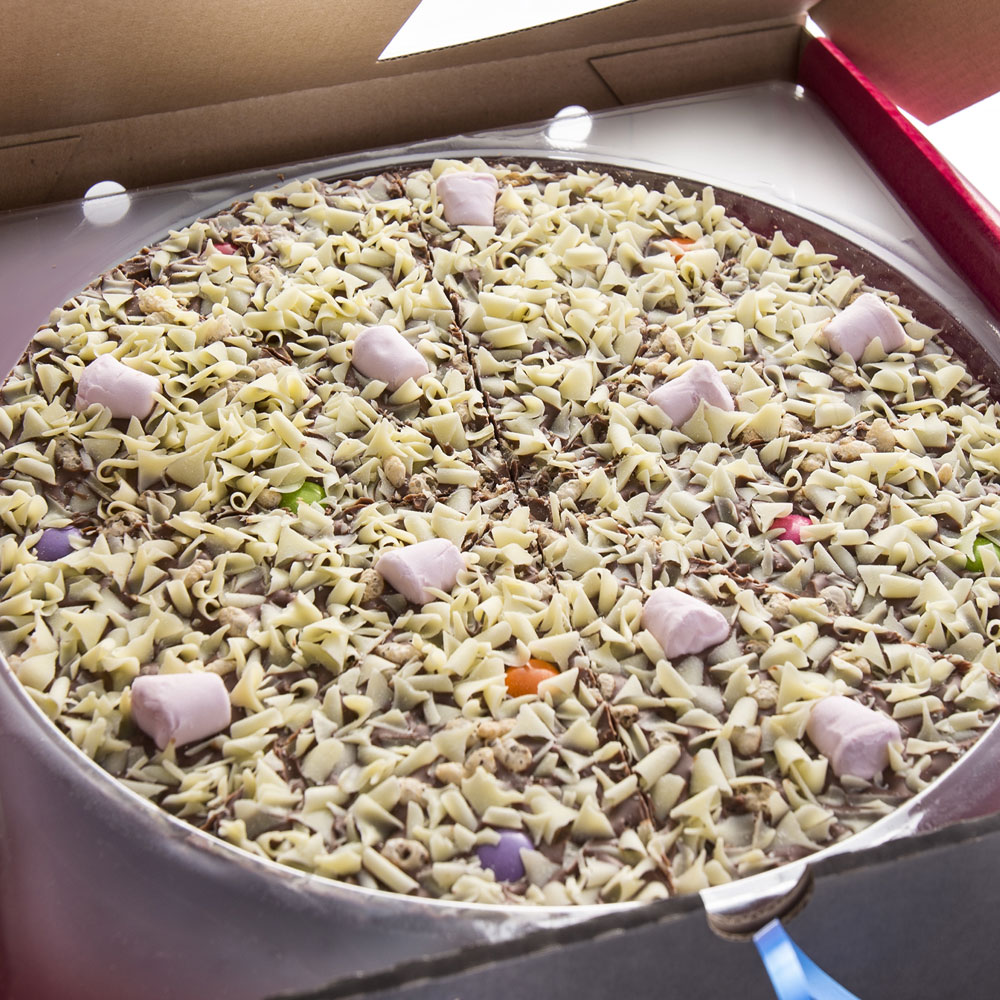 Each Yummy Scrummy Chocolate Pizza is topped with white chocolate curls, mini marshmallows, rainbow chocolate drops and crispy puffed rice.